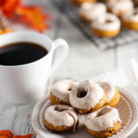 Pumpkin Roll Donuts, Bite-sized, spiced just right pumpkin donuts are topped with a cinnamon cream cheese glaze to  create perfectly poppable pumpkin roll donuts. 