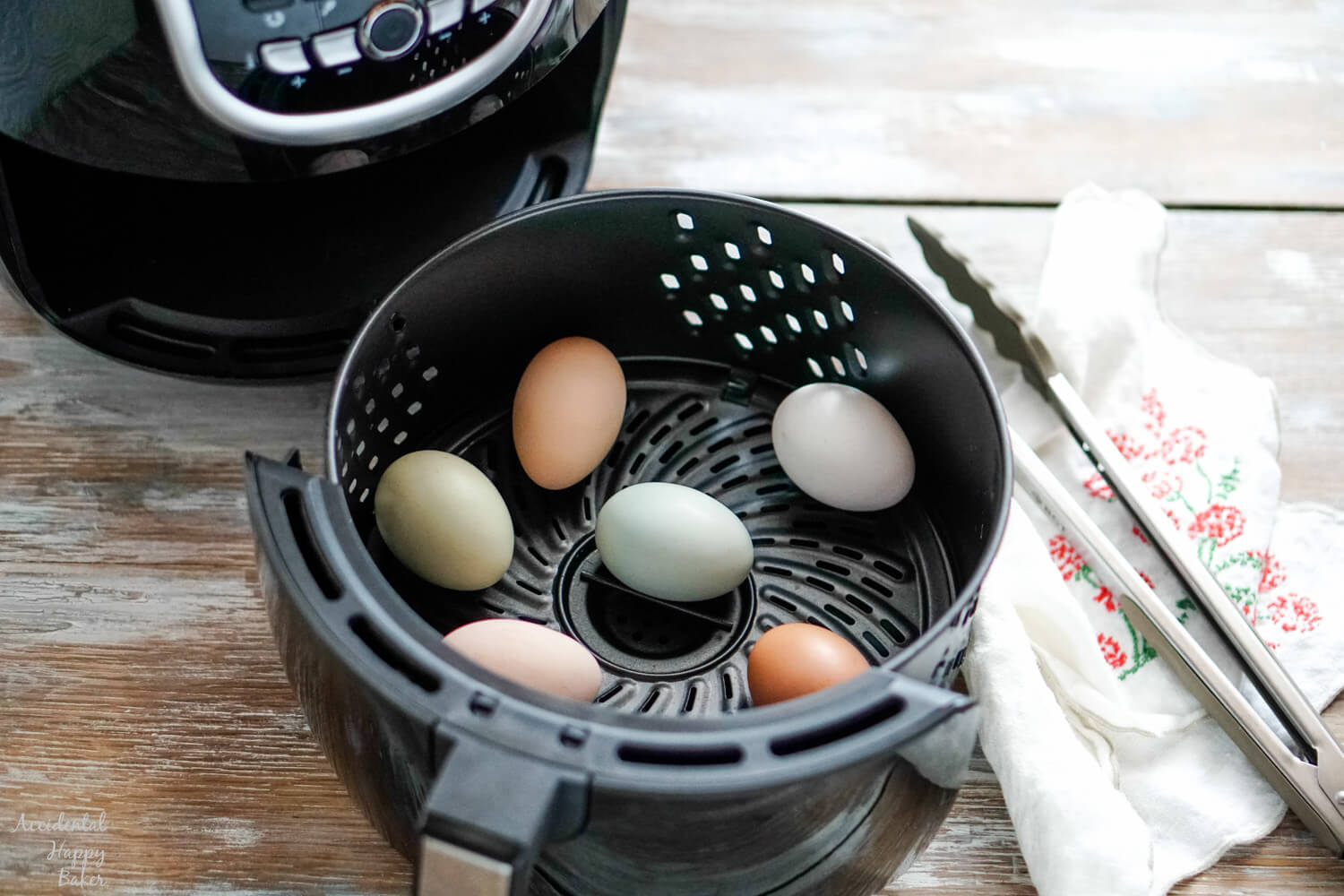 Several eggs in the basket of an air fryer. 